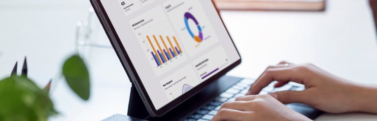 Person using a desktop with sustainability analytics dashboard, charts and product data on screen, symbolizing automated life cycle assessment and environmental impact analysis.