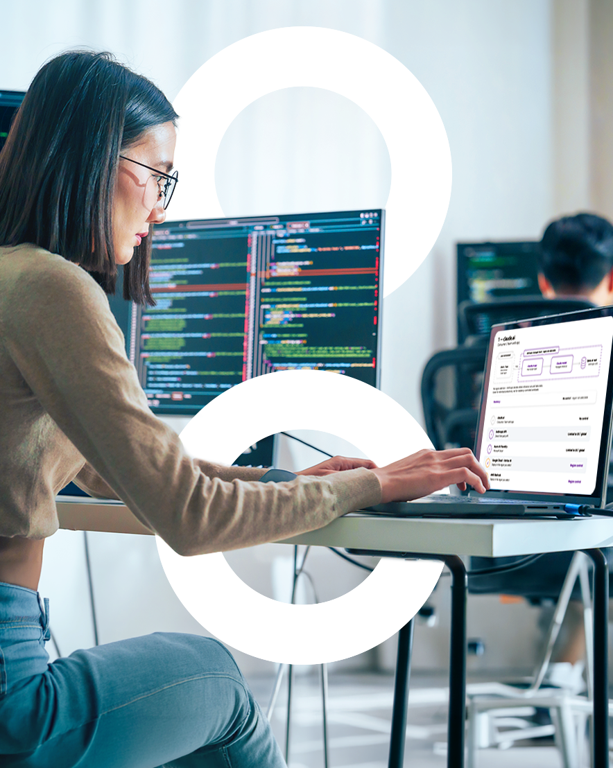 Woman working on a laptop in an office environment.