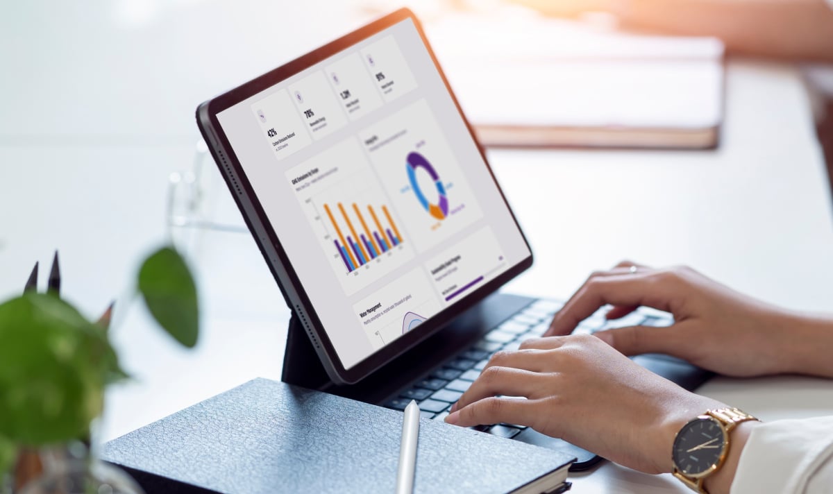 Featured image with a tablet featuring sustainable packaging case study content, overlaid on continuous gradient wave patterns symbolizing automated lifecycle analysis.