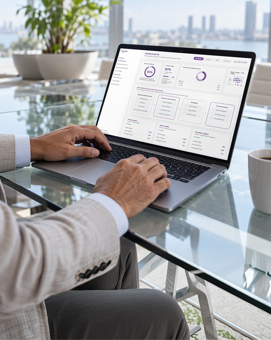 Hands using a laptop showing a contextual AI dashboard in a modern office.